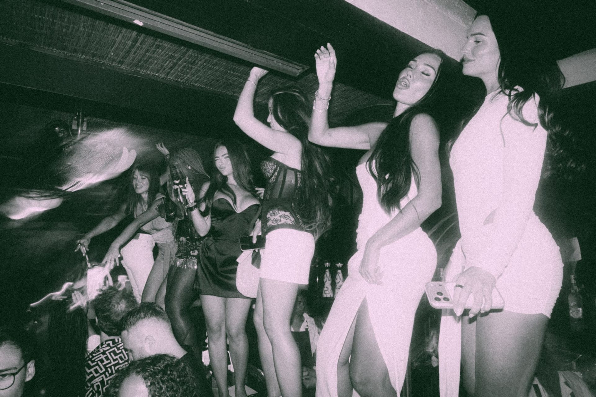 Guests dancing on the banquette, black and white