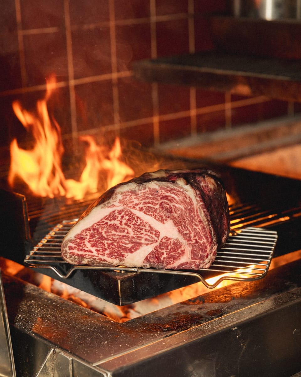 Marbled beef over the flames of the wood fire grill