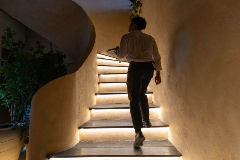 A member of the Giselle team climbing the lit staircase